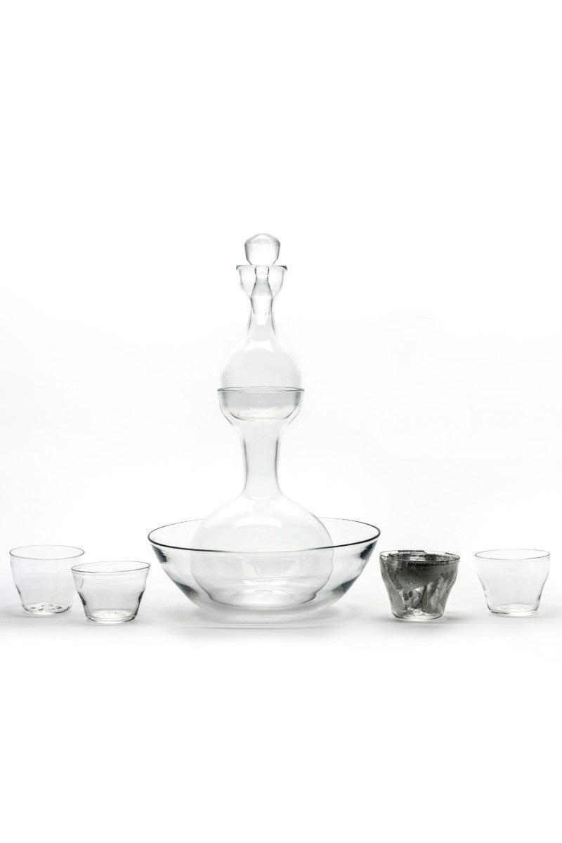 Clear glass decanter and tumblers on a white background