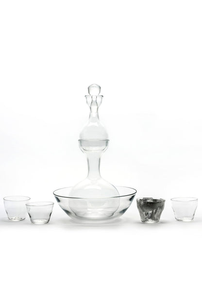 Clear glass decanter and tumblers on a white background