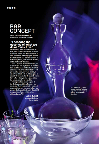 Glass decanter with text on a dark background